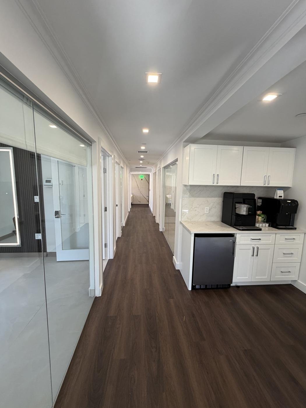 Salon hallway with a wired coffee bar and under-cabinet refrigerator